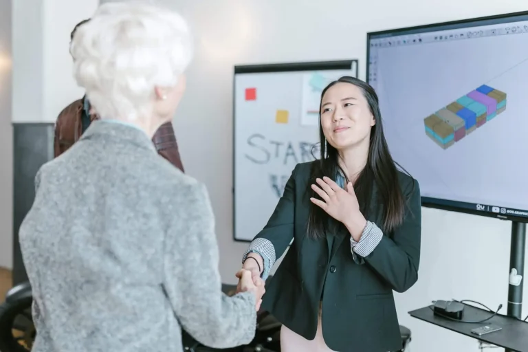 two women shaking their hands pre seed startup funding