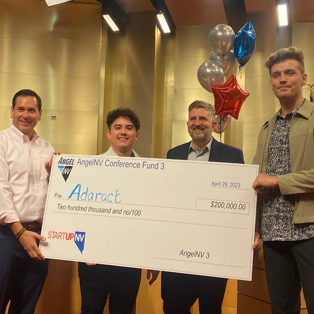 NV Secretary of State Cisco Aguilar and Jeff Saling of StartUpNV present investment check to Adaract founders Marcus D'Ambrosio and Clay Payson.