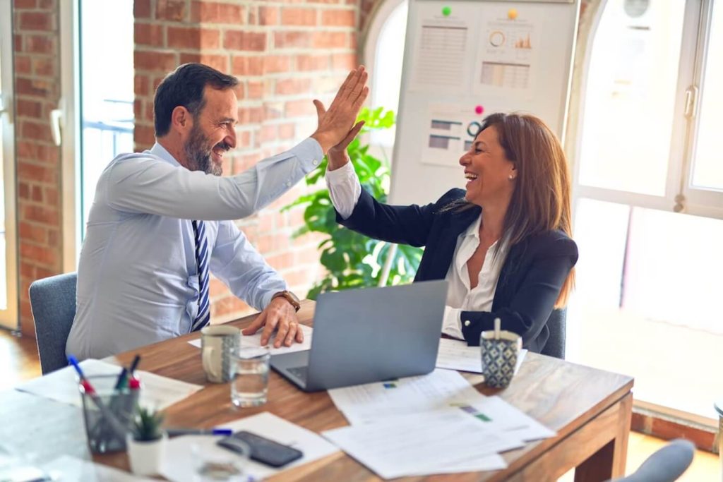 man and woman doing high five on work pre-seed fund 3