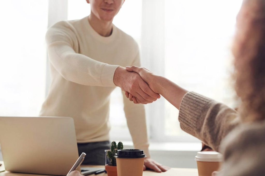 Man and woman shake hands