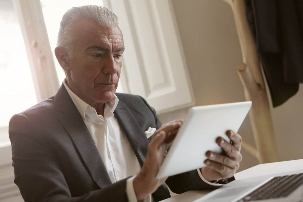 old man uses his tablet software development and consulting services 11