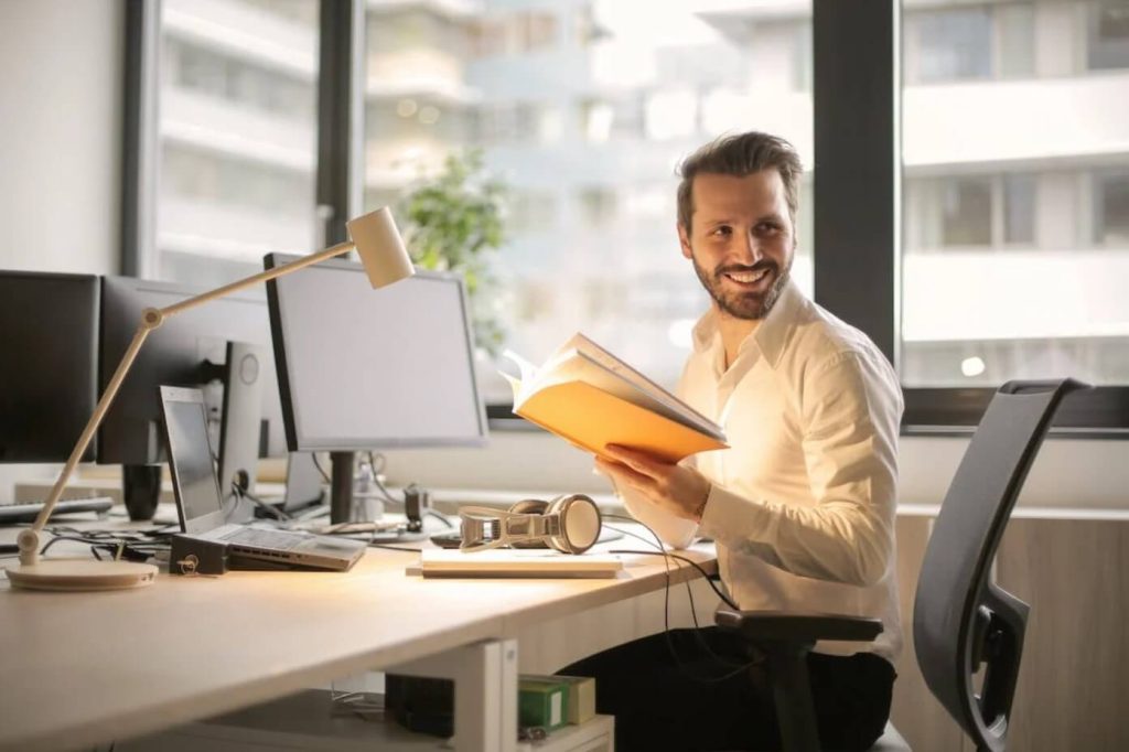 smiling man holding a book angel investors las vegas