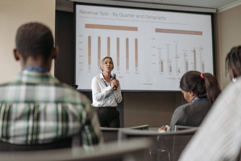 woman speaking in front of people incubator entrepreneurship program 1