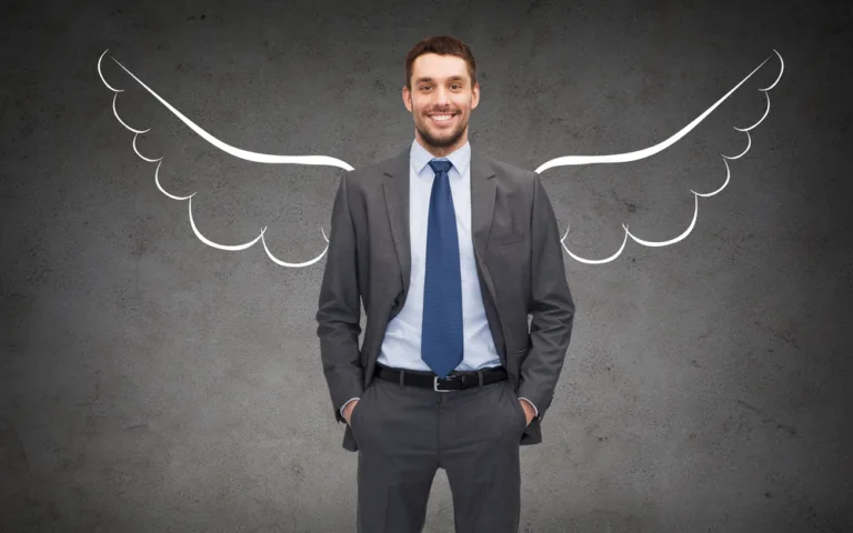 Angel Investor photo - Happy businessman with angel wings over gray background